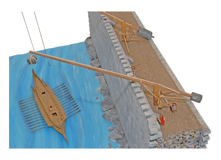 Reconstructed stone-throwing crane of Archimedes with a suspended load above a model ship